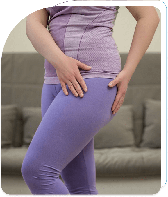 Person experiencing hip pain and holding the affected area